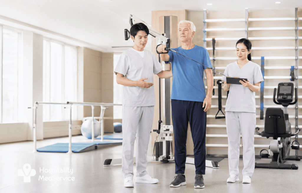An elderly European patient receives rehabilitation and therapeutic exercise training under the supervision of Chinese medical professionals